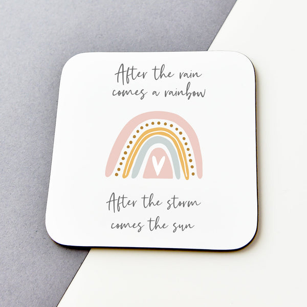 A white coaster with a positive quote and a scandi rainbow. the coaster is on a grey background